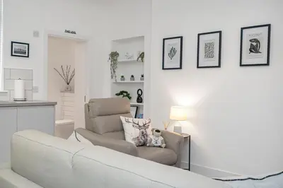 a living room with a couch and a chair at Coaledge Coorie - A wee find in Fife in Fordell