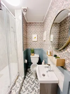 a bathroom with a toilet and a sink and a mirror at Chic flat close to Edinburgh, Airport, & Zoo in Edinburgh