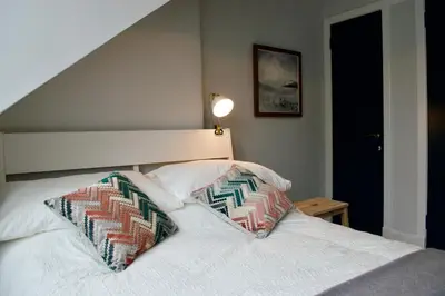a bedroom with a bed with two pillows on it at The Muse in Edinburgh
