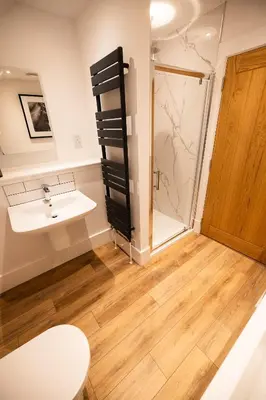 a bathroom with a sink and a shower at Thistle Lodge in Comrie