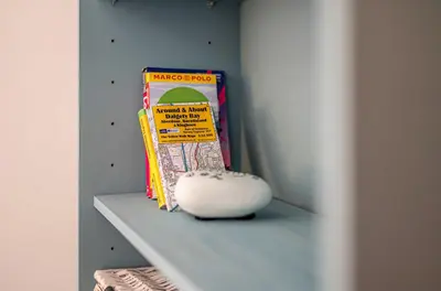 a shelf with a book and a ball on it at Number Two Aberdour - Pretty Village nr Edinburgh in Aberdour