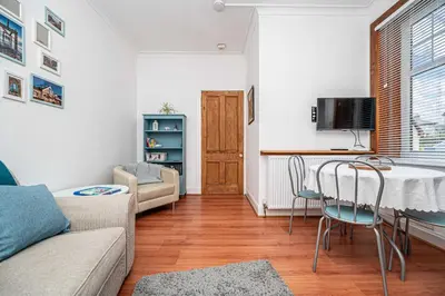 a living room with a table and chairs at Number Two Aberdour - Pretty Village nr Edinburgh in Aberdour