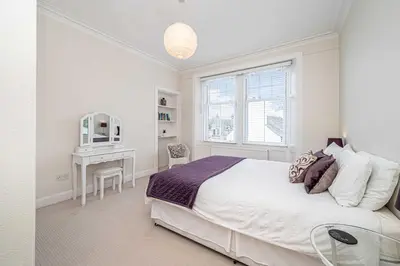 a white bedroom with a bed and a desk at Number Two Aberdour - Pretty Village nr Edinburgh in Aberdour