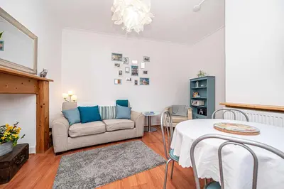 a living room with a couch and a table at Number Two Aberdour - Pretty Village nr Edinburgh in Aberdour