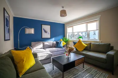 a living room with two couches and a table at Camps Rigg Place in Livingston