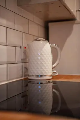a coffee pot sitting on top of a counter at Bonnie Apartment in Coatbridge