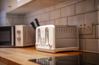 a toaster sitting on a counter in a kitchen at Bonnie Apartment in Coatbridge