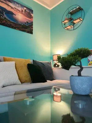 a living room with a couch and a glass table at King Apartment in Falkirk