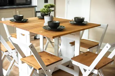 a wooden table with black bowls on top of it at Spacious 3 Bed Home in Glasgow City With Free Parking in Glasgow