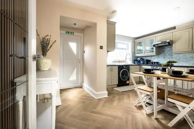 a kitchen with a table and a dining room at Spacious 3 Bed Home in Glasgow City With Free Parking in Glasgow