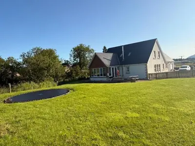 a large house with a large yard with a building at Gellyburn Cottage in Kinross