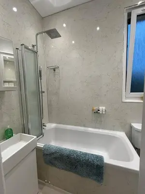 a bathroom with a tub and a sink and a toilet at Bright Top Floor 2BR Apartment in Morningside, Easy City Centre Links, Close to University and Royal Hospital in Edinburgh