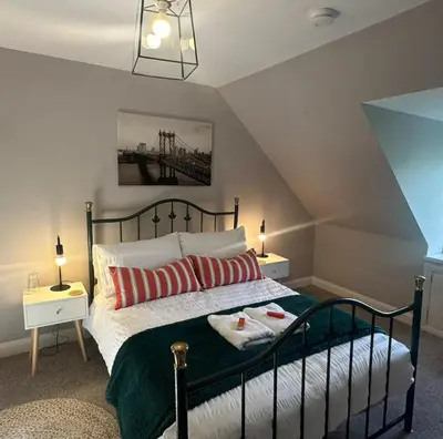 a bedroom with a bed with two towels on it at Charming Snug Loft Room, Room 4, Beautiful Connel near Oban in Connel