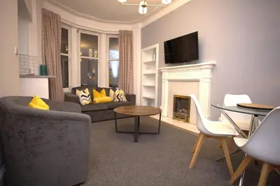a living room with a couch and a fireplace at Renovated West End Flat in Glasgow in Glasgow