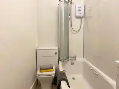 a bathroom with a shower and a toilet and a tub at Renovated West End Flat in Glasgow in Glasgow