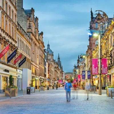 a city street with people walking down the street at Renovated West End Flat in Glasgow in Glasgow