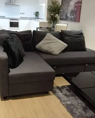 a living room with a couch with pillows on it at Apartment In Canary Wharf, London in Moffat
