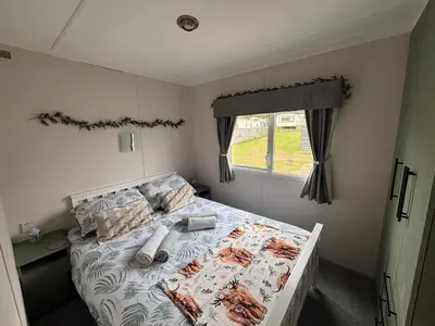 a bed in a small room with a window at No 38 Heilan Hoose at Three Lochs Newton Stewart in Newton Stewart