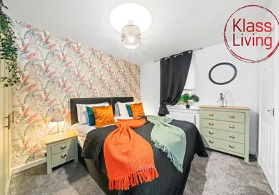 a bedroom with a bed with an orange blanket at Colt Apartment by Klass Living Coatbridge in Glenboig