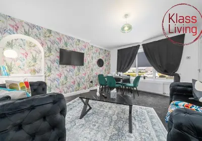 a living room with a table and chairs at Orbiston House by Klass Living Bellshill in Bellshill