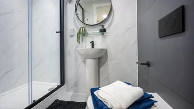 a white bathroom with a sink and a mirror at For Students Only Clyde Court Glasgow in Glasgow