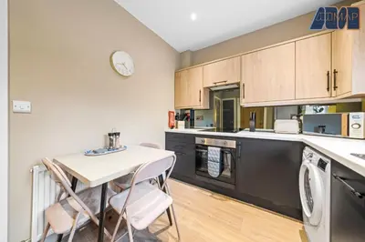 a kitchen with a table and chairs in a room at 3Bed Home Sleeps 6 w Private Parking in Dunfermline