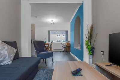 a living room with a couch and a table at Vacant Nests The Grampian Free Wifi in Wishaw