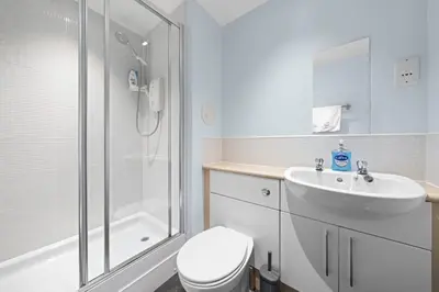 a bathroom with a toilet and a sink and a shower at Slateford 2 Bedroom Apartment - Edinburgh in Edinburgh