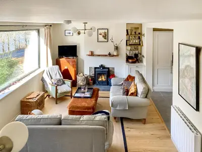 a living room with two couches and a fireplace at Alt Na Blathaich in Coirantee