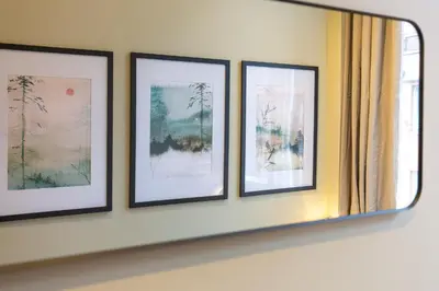 a group of four framed pictures on a wall at Quiet City Centre, King & Sofa Bed in Glasgow