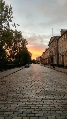 an empty street with a sunset in the distance at Quiet City Centre, King & Sofa Bed in Glasgow