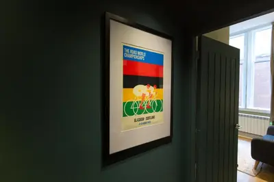 a framed poster of a couple on a bike on a wall at Quiet City Centre, King & Sofa Bed in Glasgow