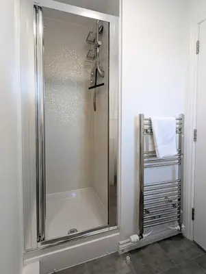 a shower with a glass door in a bathroom at Pilmuir Apartment 3 bed 2 bath in Dunfermline