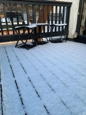 a table and chairs on a porch covered in snow at Mountain View Self Catering Ballachulish Glencoe in North Ballachulish