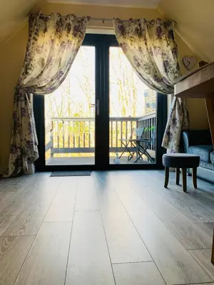 a living room with a large window with curtains at Mountain View Self Catering Ballachulish Glencoe in North Ballachulish