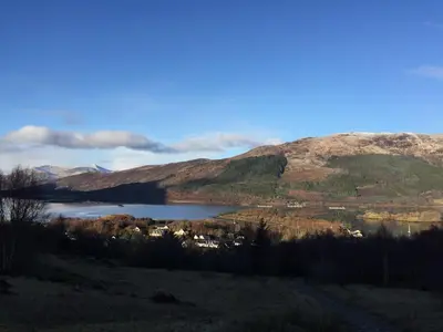a lake in the middle of a valley with mountains at Mountain View Self Catering Ballachulish Glencoe in North Ballachulish