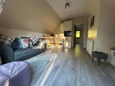 a living room with a couch and a table at Mountain View Self Catering Ballachulish Glencoe in North Ballachulish