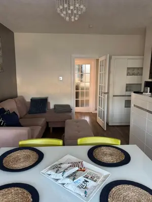 a living room with a table and yellow chairs at City break in Edinburgh