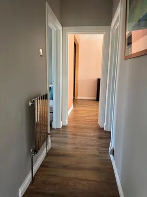 a hallway with white doors and wood floors at City break in Edinburgh