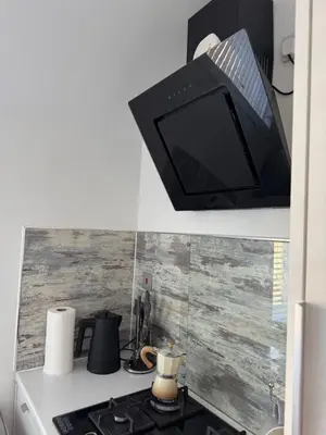 a television is hanging above a stove in a kitchen at City break in Edinburgh