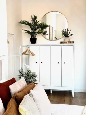 a living room with a white cabinet with a mirror at Castlegreen Lux Apartment in Dumbarton