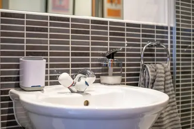 a bathroom sink with a faucet next to a mirror at Stylish Studio Finnieston City Centre Free Parking in Glasgow