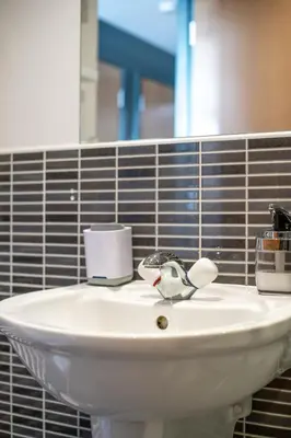 a white sink in a bathroom with a mirror at Stylish Studio Finnieston City Centre Free Parking in Glasgow