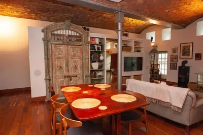 a living room with a table with chairs and a couch at Unique House in Park District in Glasgow