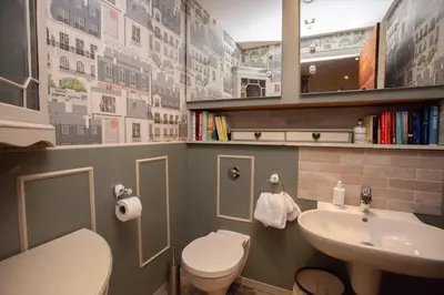 a small bathroom with a sink and a toilet at Unique House in Park District in Glasgow