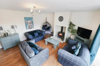 a living room with two couches and a tv at JOIVY Greenknowes Lodge with Hot Tub and Wood Burning Stove in Kelty