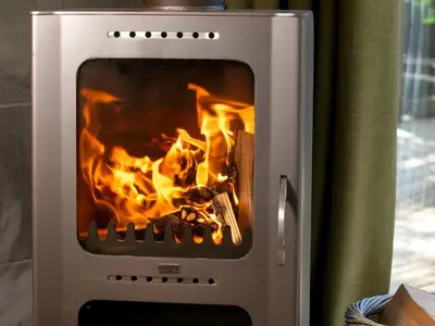 a fire inside of a oven with flames at Ardgartan Argyll Cabins - Forest Holidays in Arrochar