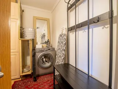 a laundry room with a washer and a washing machine at Metropolitan St Andrews Cathedral View - Pass the Keys in Glasgow