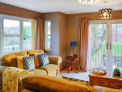 a living room with a couch and chairs and windows at Norwood in Thornhill