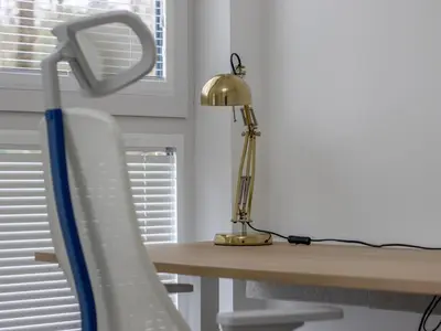a desk with a lamp and a white chair at Fabulous Festival Park Home Private Parking Garden - Pass the Keys in Glasgow